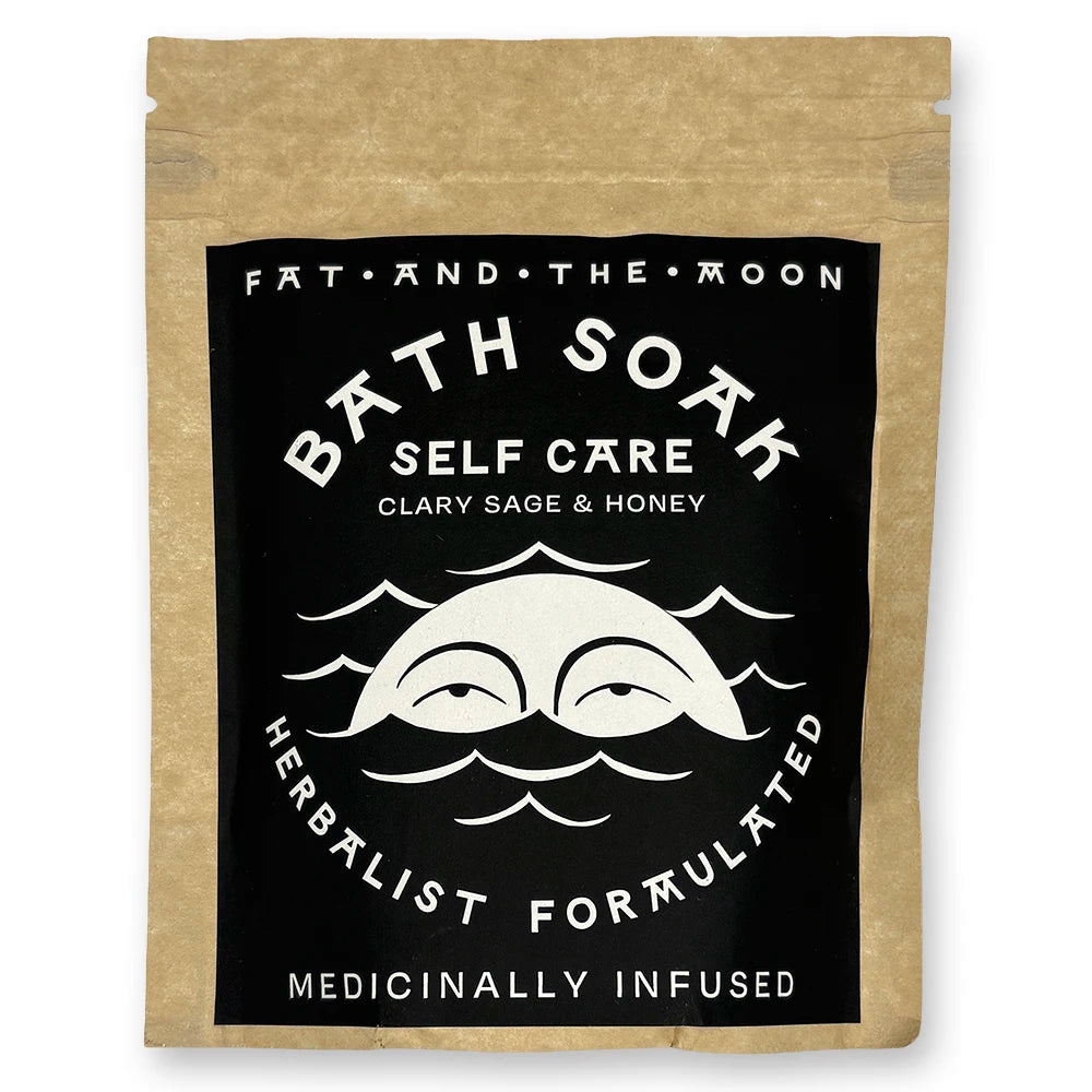 Brown kraft pouch with black and white label with half-moon face.