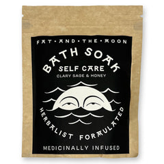 Brown kraft pouch with black and white label with half-moon face.