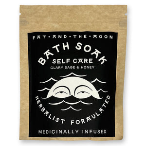 Brown kraft pouch with black and white label with half-moon face.