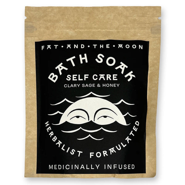 Brown kraft pouch with black and white label with half-moon face.