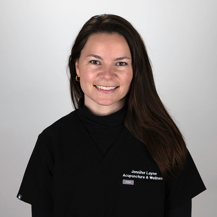 Headshot of Alexa Wilson, smiling, wearing black scrubs.