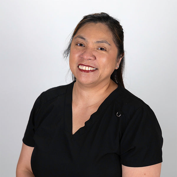 Headshot of Ela Acuna, smiling, wearing a black shirt.