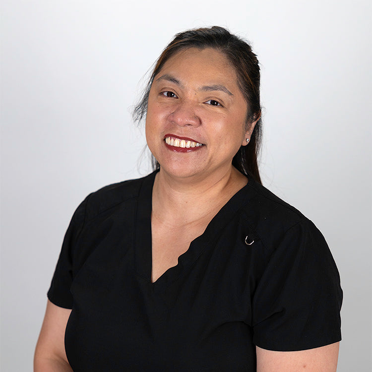 Headshot of Ela Acuna, smiling, wearing a black shirt.