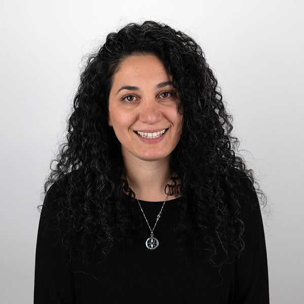 Headshot of Gabriella Sahyoun, smiling, wearing a black shirt.