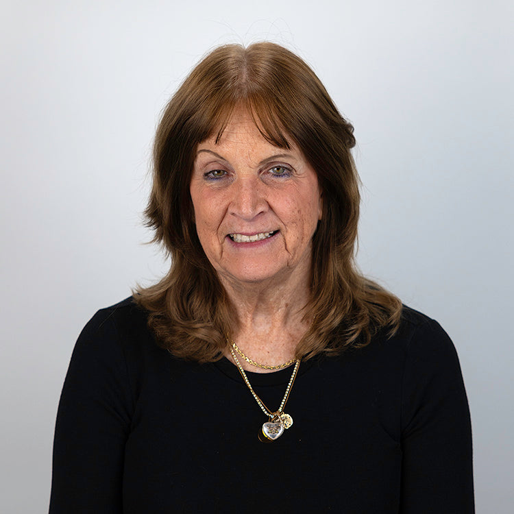 Headshot of Jan Jiosi, smiling, wearing a black shirt.