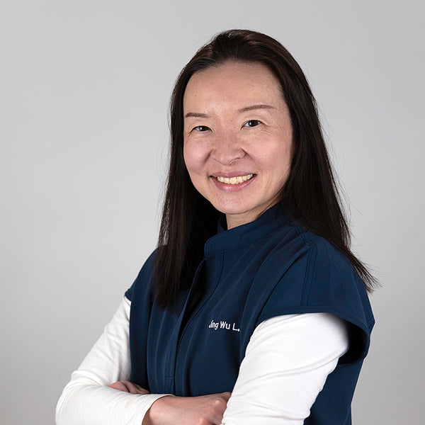 Headshot of Jing Jing Wu, smiling, wearing blue scrubs.