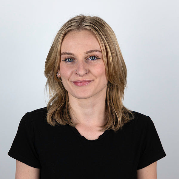 Headshot of Lili Fieldhouse, smiling, wearing a black shirt.
