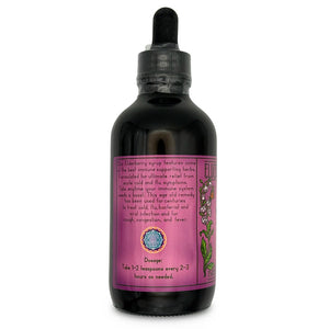Dark bottle with dropper cap and descriptions and dosage on the pink/purple label.
