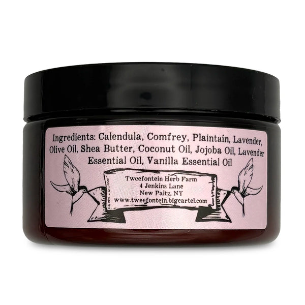 Back of dark jar with black top, and ingredients on lavender label.